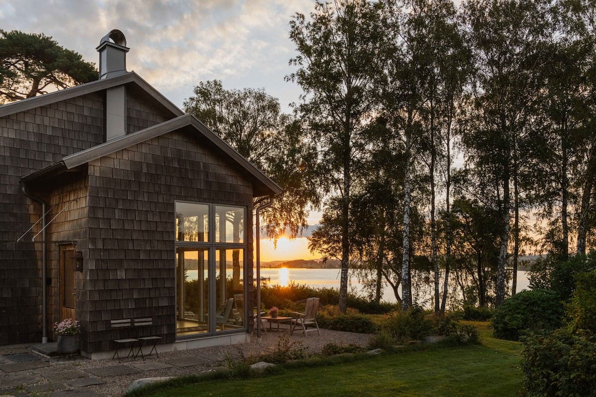 Birgitta's Fjord View Home outside Kungsbacka at sunset, the Kungsbackafjord glowing behind the birches